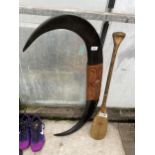 AWOODEN PADDLE AND A WOODEN PLAQUE IN THE FORM OF HORNS