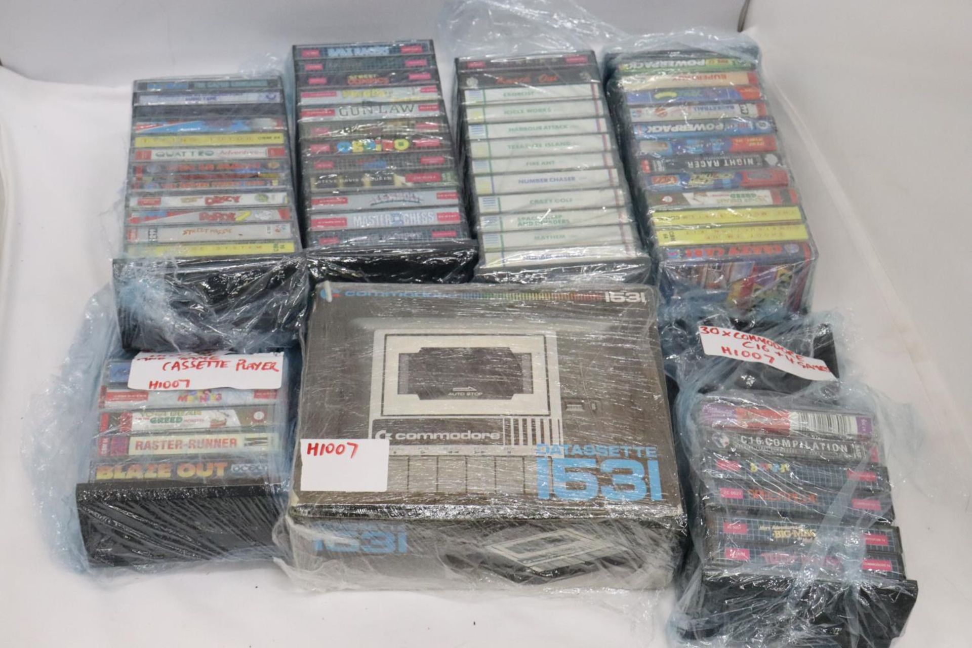 A COMMODORE DATASSETTE 1531 PLUS A LARGE QUANTITY OF COMMODORE 64 GAMES