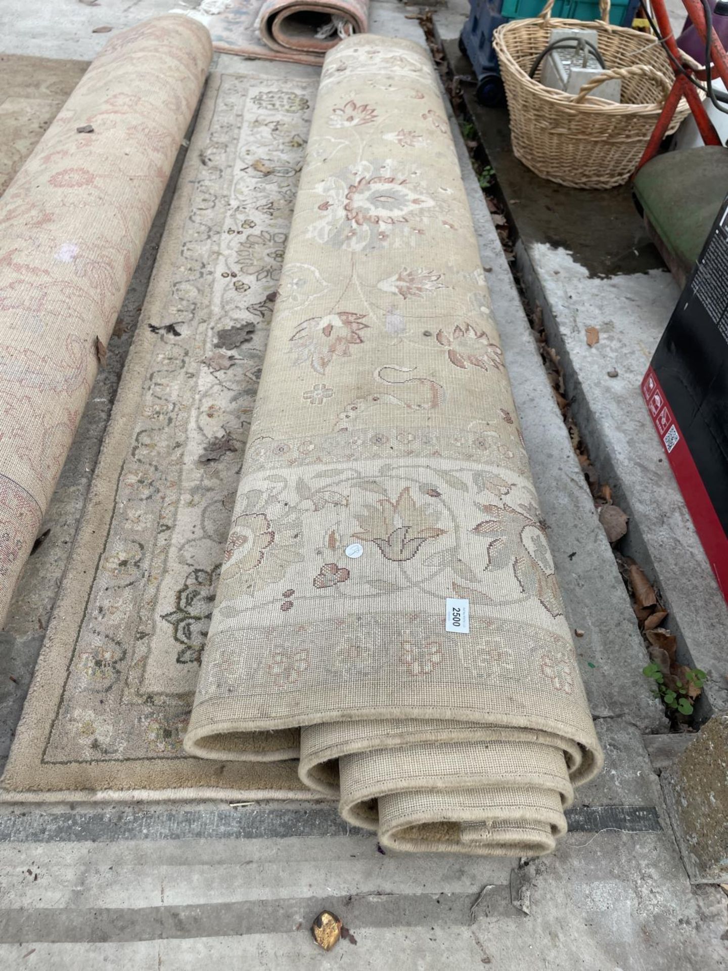 A LARGE CREAM PATTERNED RUG