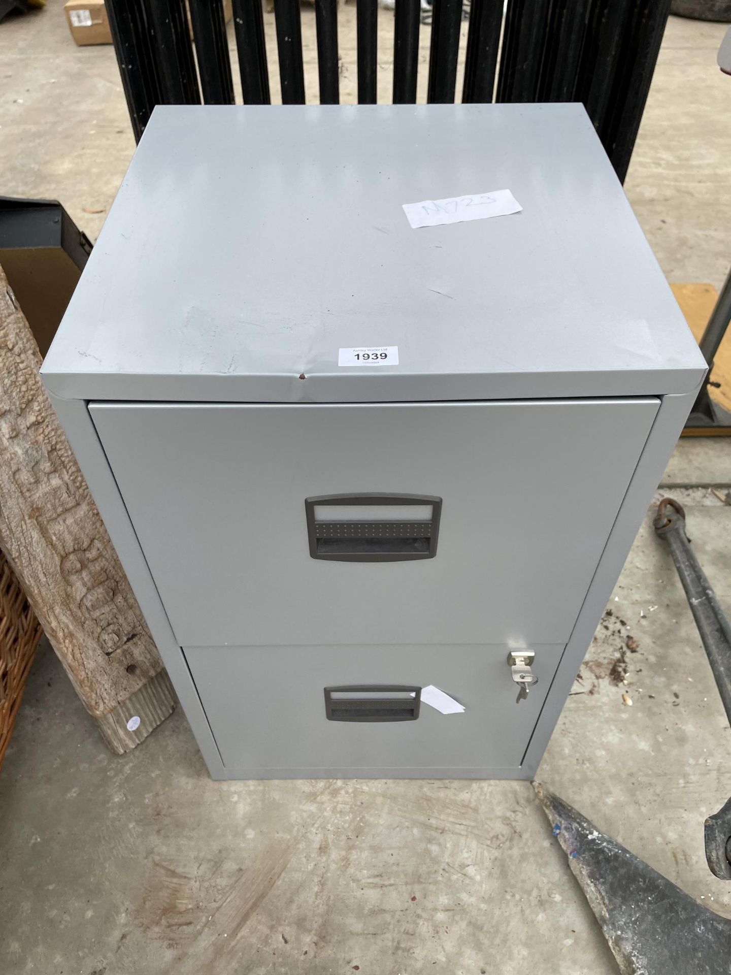 A METAL TWO DRAWER FILING CABINET