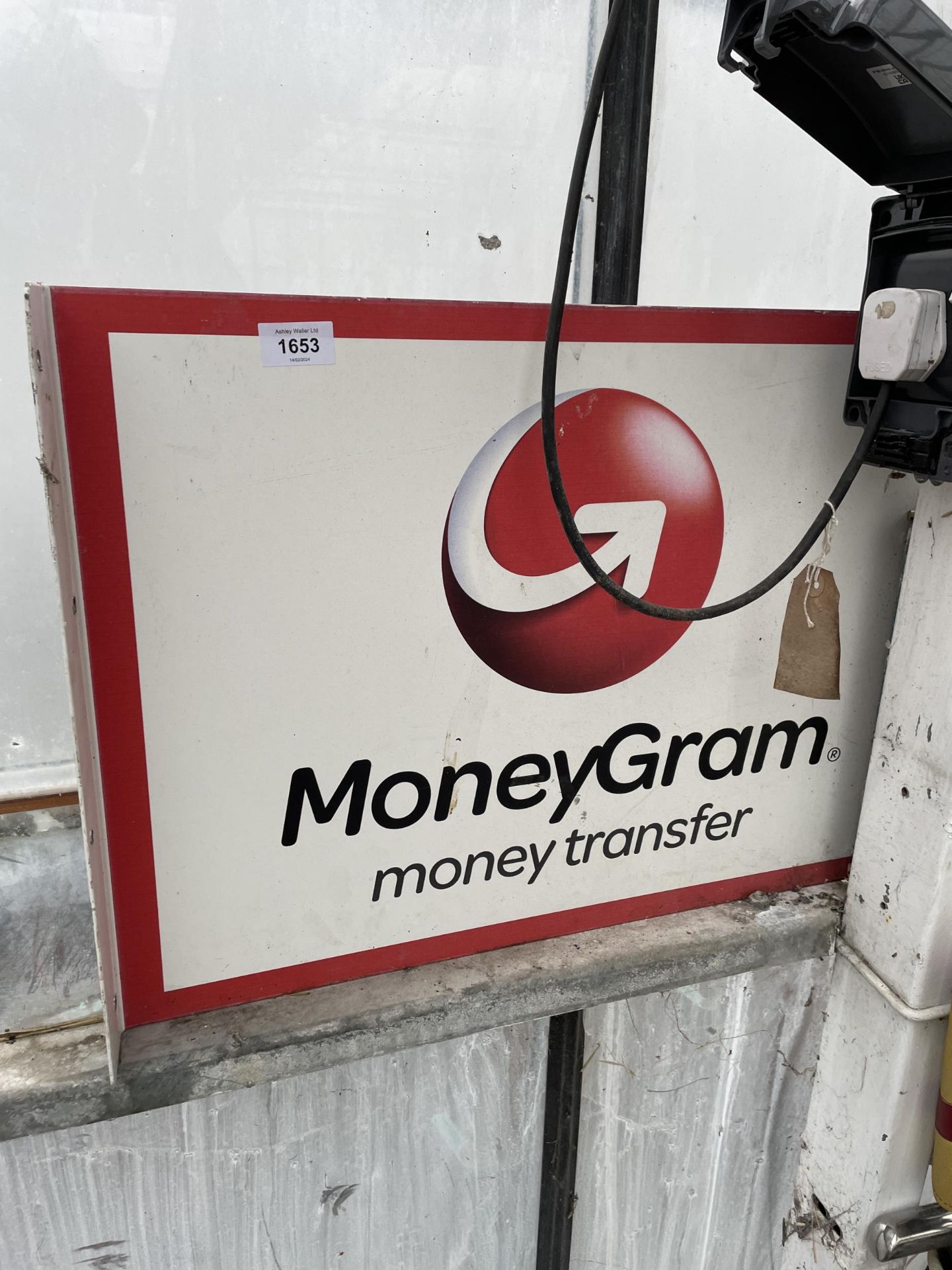 A METAL 'MONEYGRAM' WALL MOUNTED SIGN