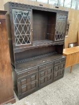 A DARK OAK REPRODUCTION DRESSER WITH GLAZED AND LEADED CUPBOARDS TO THE UPPER PORTION, 59" WIDE