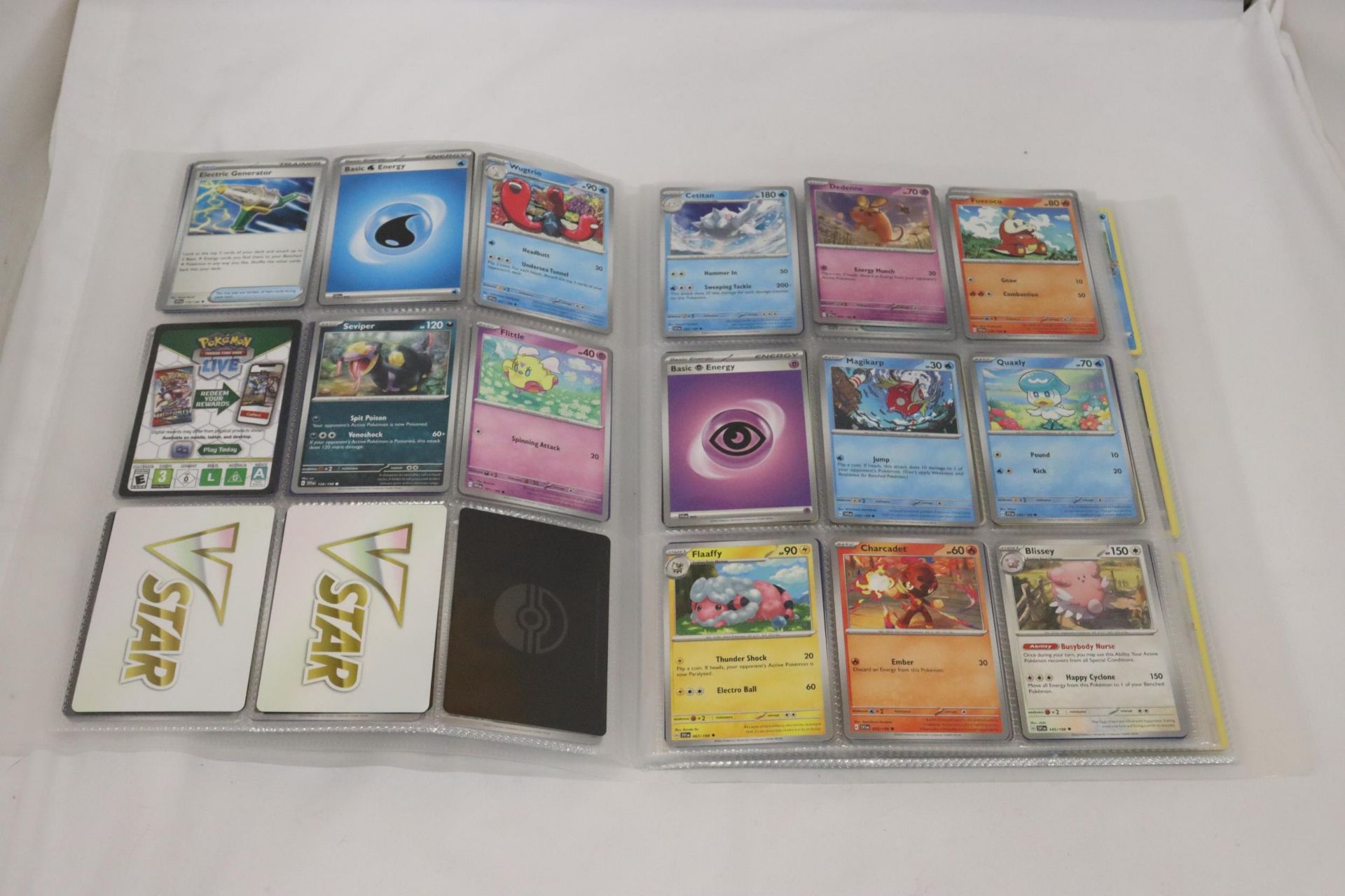 A PROTECTIVE TRADING CARD BINDER FULL OF POKEMON CARDS, INCLUDING SHINIES