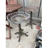 A PAIR OF VINTAGE INDUSTRIAL STYLE STOOLS WITH IMPLEMENT SEATS