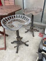 A PAIR OF VINTAGE INDUSTRIAL STYLE STOOLS WITH IMPLEMENT SEATS