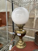 A VINTAGE BRASS OIL LAMP WITH WHITE GLASS SHADE AND CLEAR GLASS FUNNEL