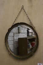 A VINTAGE ROUND MIRROR WITH GILT AND GREEN FRAME, AND CHAIN HANGING, DIAMETER 40CM