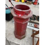 A RED PAINTED CHIMNEY POT