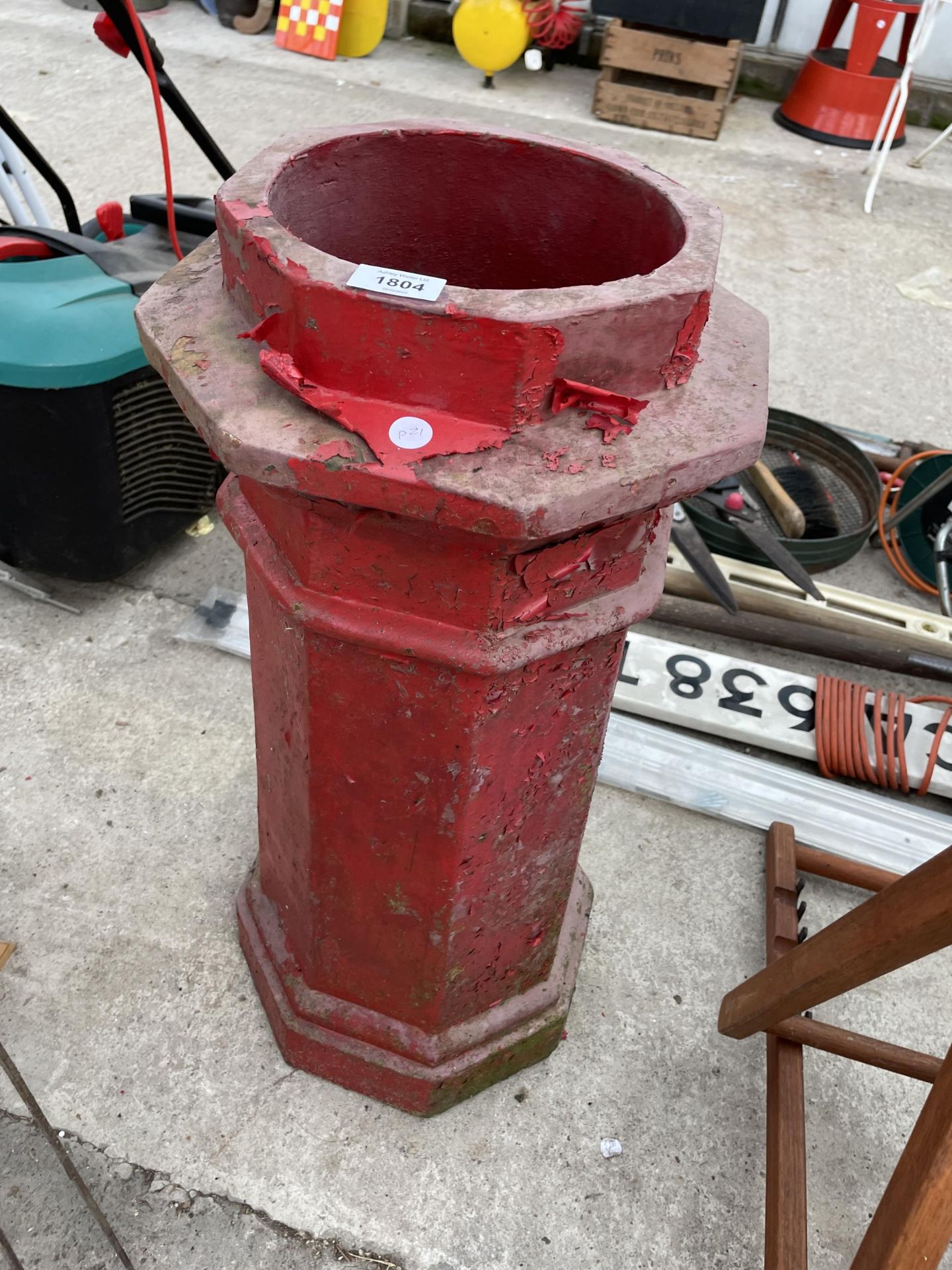 A RED PAINTED CHIMNEY POT