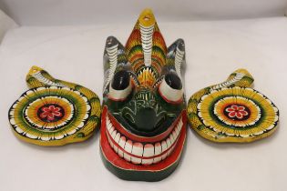 A HAND PAINTED AND HAND CARVED GUATEMALAN DEVIL GOD, 18 INCHES X 12 INCHES