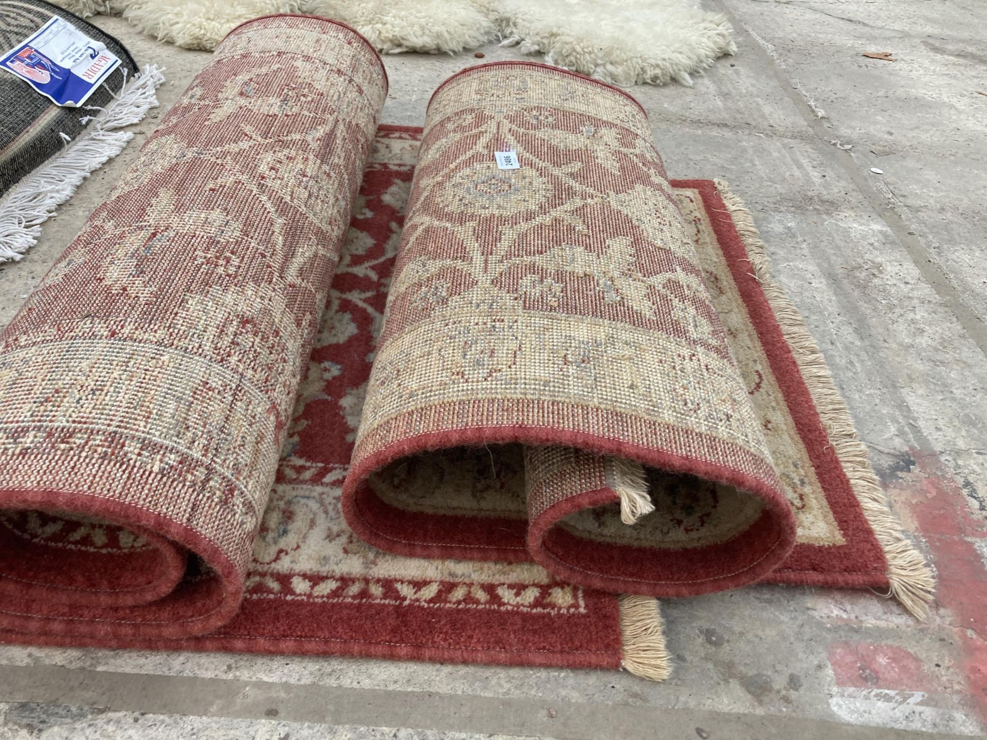 TWO SMALL RED PATTERNED FRINGED RUGS - Image 2 of 2