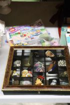 A SMALL DISPLAY CASE CONTAINING A QUANTITY OF COLLECTABLES