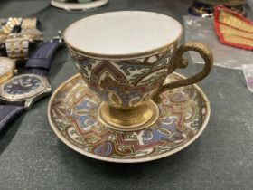A CONTINENTAL, ENAMELLED AND GILDED, CUP AND SAUCER