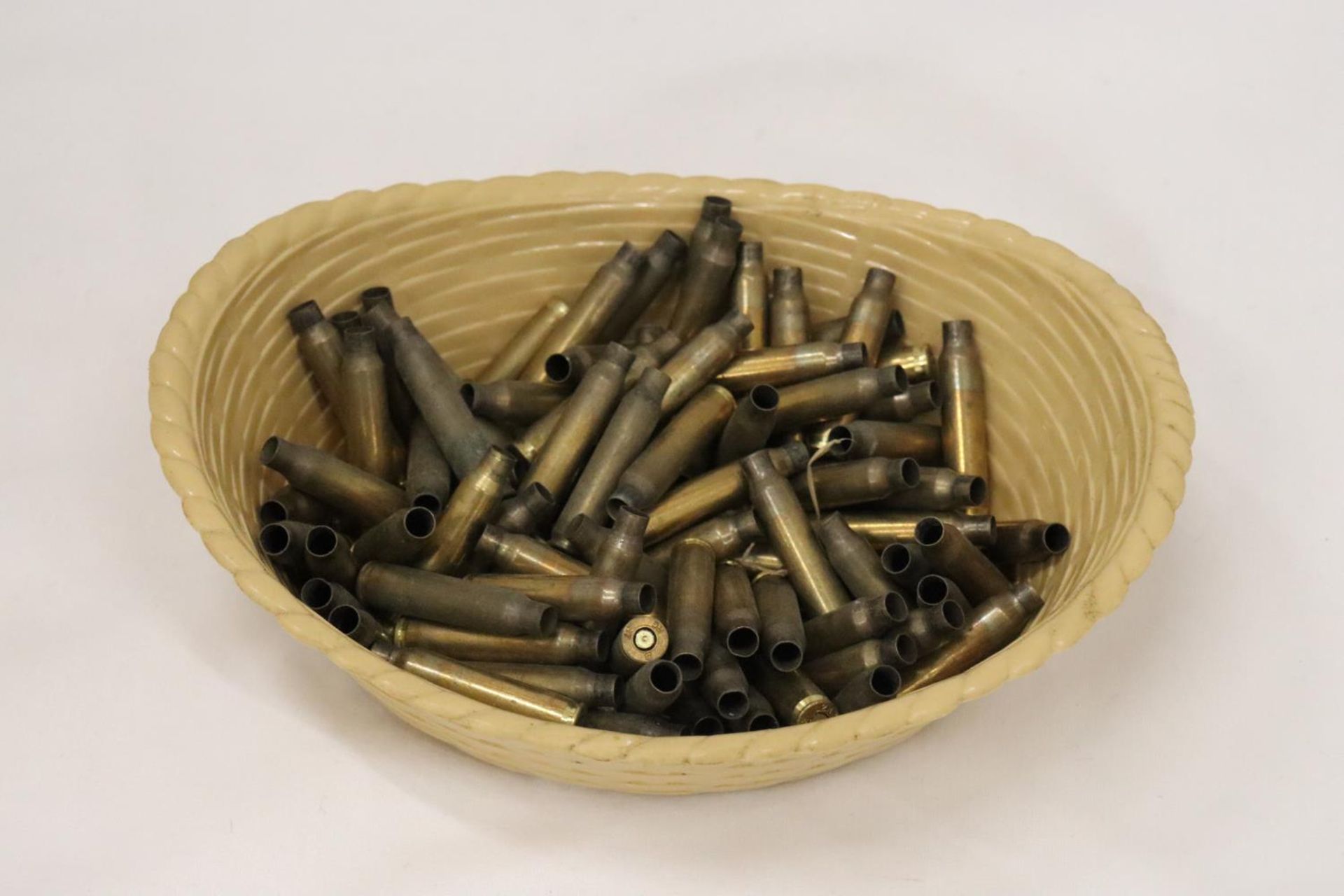 A QUANTITY OF BRASS USED BULLET CASINGS