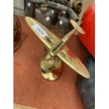 A VINTAGE BRASS AREOPLANE ON A STAND