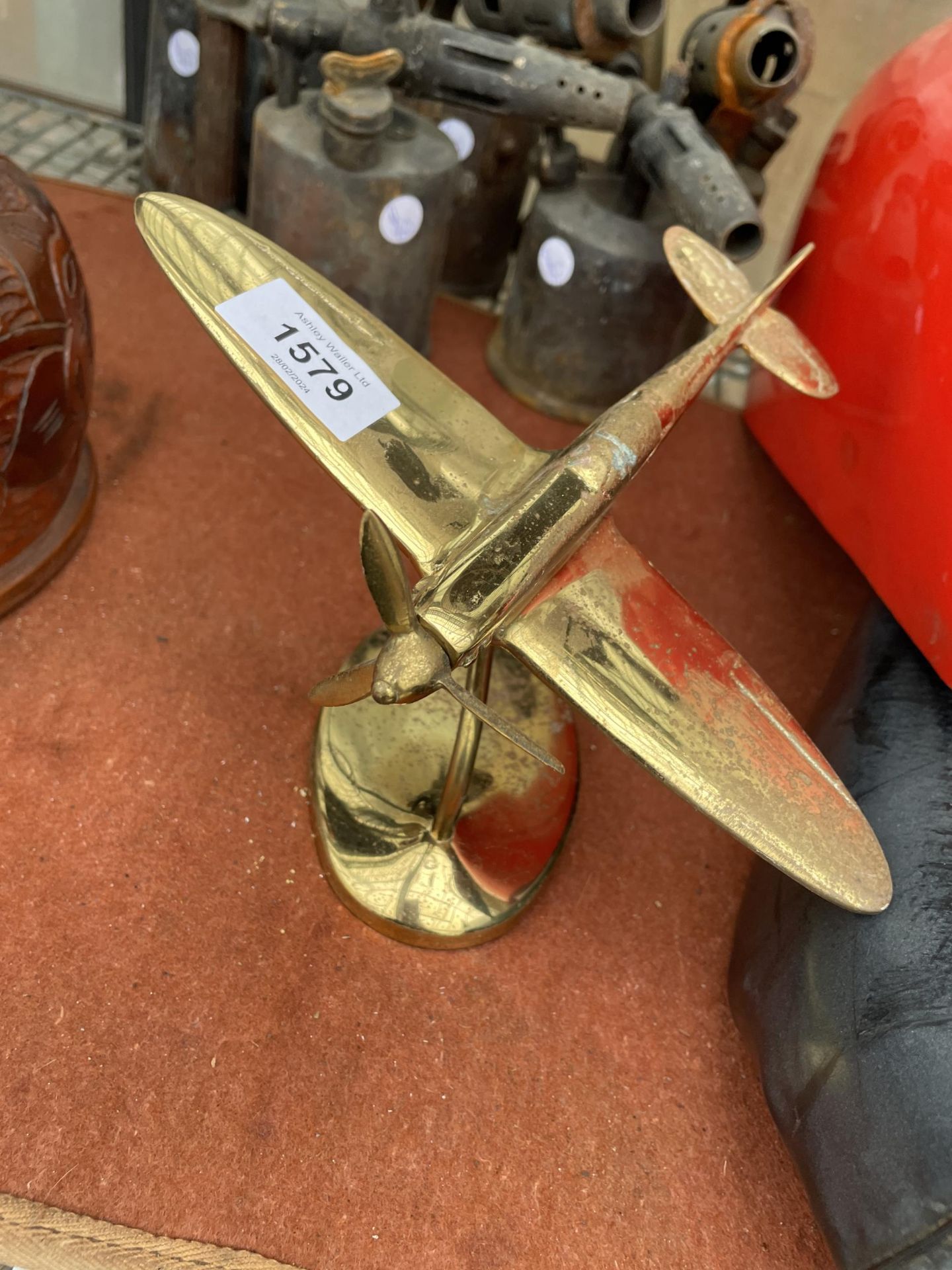 A VINTAGE BRASS AREOPLANE ON A STAND