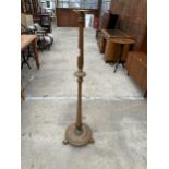 A VICTORIAN STYLE BEECH STANDARD LAMP WITH BRASS FITTINGS AND CLAW FEET