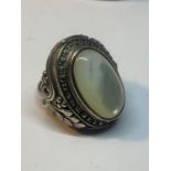 A LARGE SILVER DRESS RING WITH WHITE OPAL COLOURED STONE IN A PRESENTATION BOX