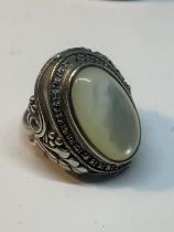 A LARGE SILVER DRESS RING WITH WHITE OPAL COLOURED STONE IN A PRESENTATION BOX