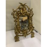 A MIRROR WITH A HEAVY BRASS DECORATIVE FRAME HEIGHT 36CM