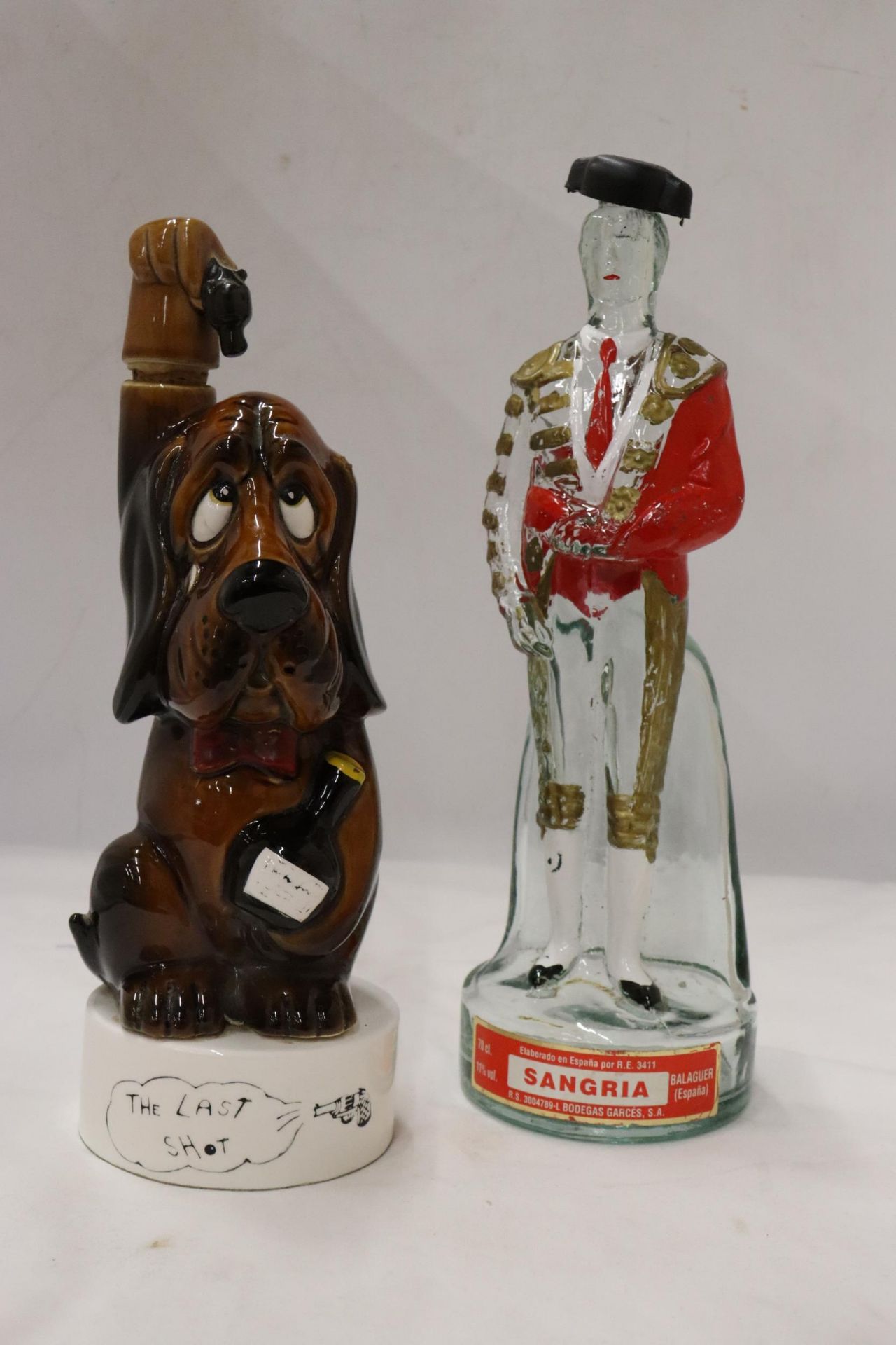 AN UNUSUAL SANGRIA DECANTER IN THE FORM OF A MATADOR AND 'THE LAST SHOT' DROOPY DECANTER
