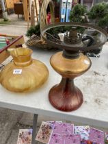 A DECORATIVE AMBER GLASS OIL LAMP WITH INDESTINCT MARK TO GLASS AND KOSMOSBRENNER ON THE BURNER