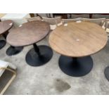 A PAIR OF PUB TABLES ON METALWARE BASES 35" DIAMETER