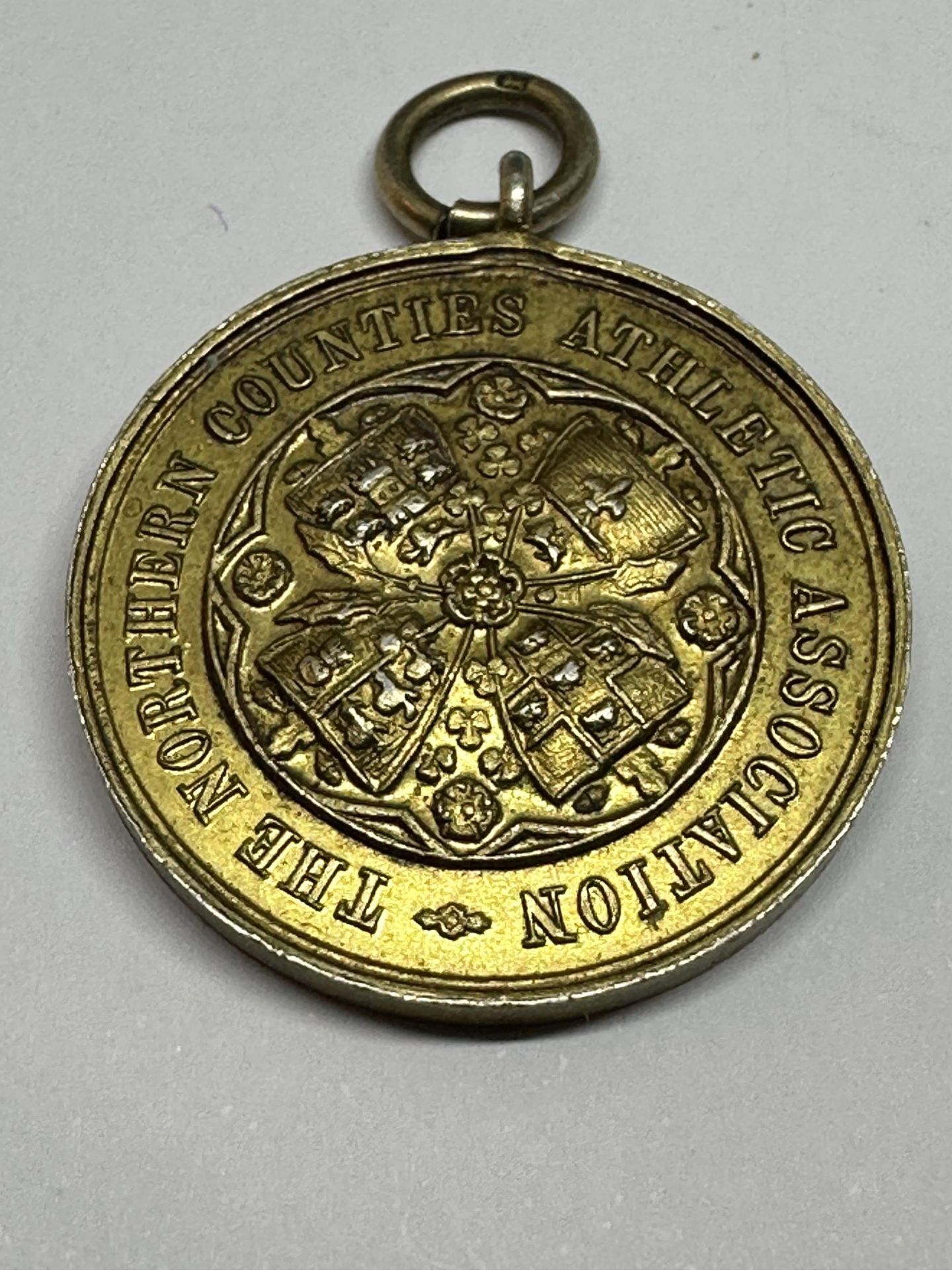 A THE NORTHERN COUNTIES ATHLETIC ASSOCIATION MEDAL BELIEVED TO HAVE BEEN WON BY SAMMY MILLER,