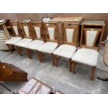 A SET OF SIX PINE DINING CHAIRS WITH UPHOLSTERED SEATS AND BACKS
