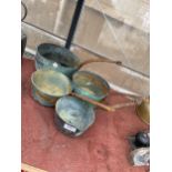 A SET OF FOUR GRADUATED COPPER PANS WITH STEEL HANDLES