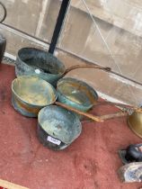 A SET OF FOUR GRADUATED COPPER PANS WITH STEEL HANDLES