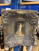 A HEAVY GILT FRAMED PAINTING OF A YOUNG GIRL WITH A GIFT BOX