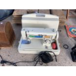 A TOYOTA ELECTRIC SEWING MACHINE WITH FOOT PEDAL AND CARRY CASE