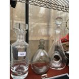 THREE VARIOUS GLASS DECANTERS