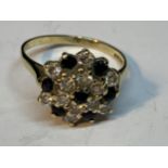 A 9 CARAT GOLD RING WITH A CLUSTER OF SAPPHIRES AND CUBIC ZIRCONIAS SIZE N/O