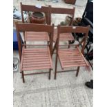 A SET OF FOUR TEAK FOLDING GARDEN CHAIRS