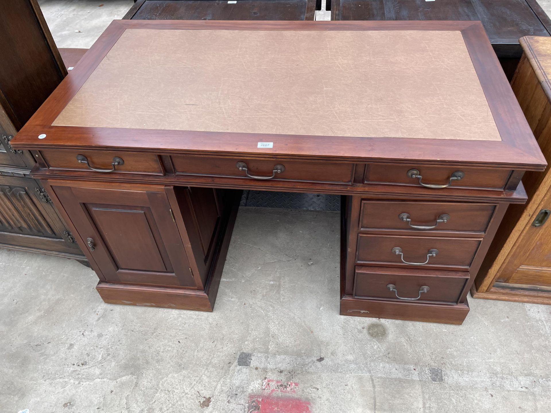 A TWIN PEDESTAL OFFICE DESK ENCLOSING SIX DRAWERS AND ONE CUPBOARD 53" X29"