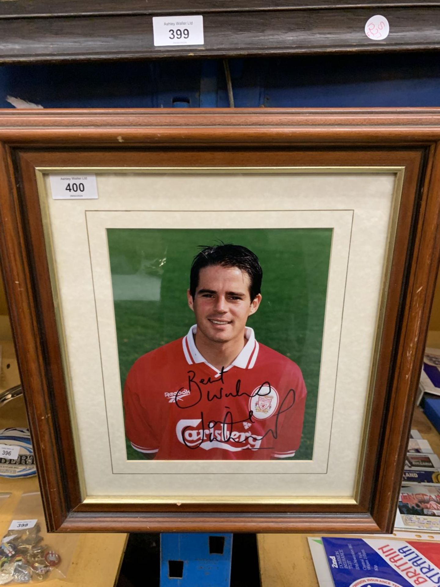 A SIGNED FRAMED PHOTO OF JAMIE REDKNAPP, IN LIVERPOOL COLOURS, WITH CERTIFICATE OF AUTHENTICITY TO