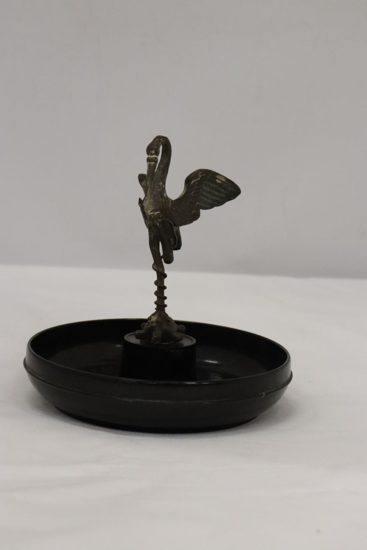 A VINTAGE BAKELITE PIN DISH WITH A PEWTER STORK