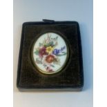 A ROYAL WORCESTER OVAL BROOCH