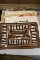 A VINTAGE 'AUTOBRIDGE' CONTACT BRIDGE SET WITH PLAYING BOARD AND DEAL SHEETS