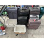 AN ASSORTMENT OF SUITCASES AND WICKER BASKETS ETC