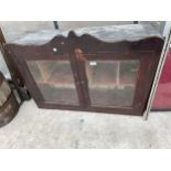 A VINTAGE MAHOGANY WALL UNIT WITH INTERNAL PIGEON HOLE SECTIONS AND GLASS DOORS