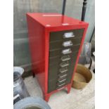 A RED PAINTED METAL TEN DRAWER MINIATURE FILING CABINET