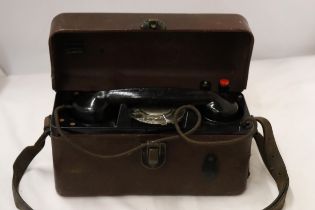 A WORLD WAR 11 MILITARY TELEPHONE IN A LEATHER CASE