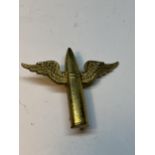 A BRASS ROYAL AIR FORCE AIR GUNNER BADGE WITH BULLET AND WING DESIGN