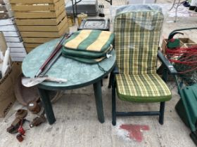 A PLASTIC GARDEN TABLE AND A FOLDING CHAIR