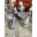 AN ASSORTMENT OF GARDEN CONCRETE FIGURES TO INCLUDE PLAQUES AND WHINNIE THE POOH ETC