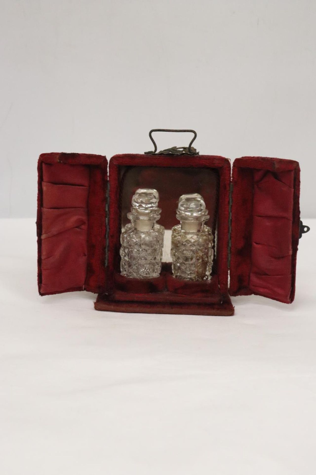 TWO PERFUME BOTTLES IN ORIGINAL PRESENTATON CASE OF CRUSHED VELVET