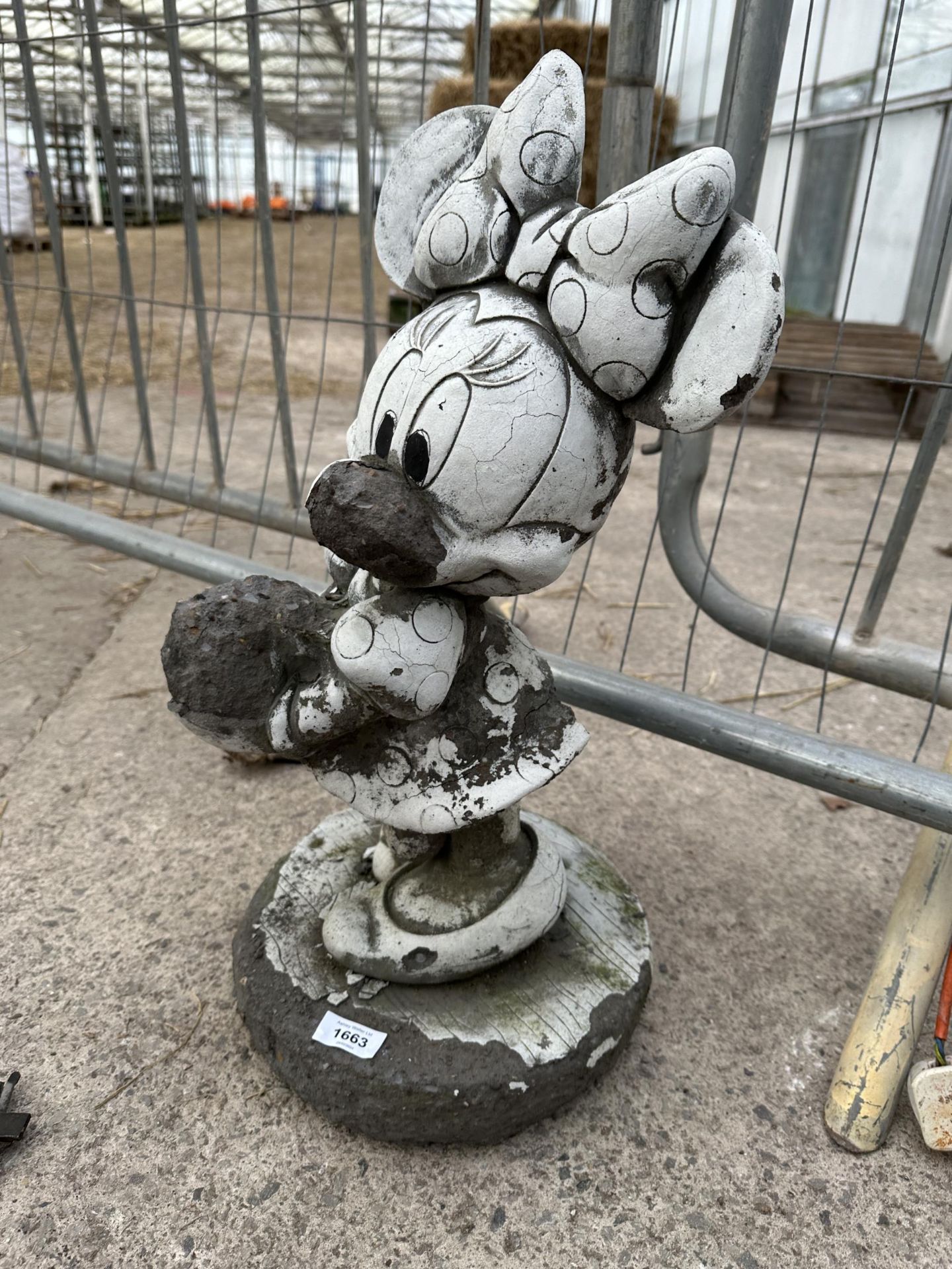 A CONCRETE GARDEN FIGURE OF MINNIE MOUSE